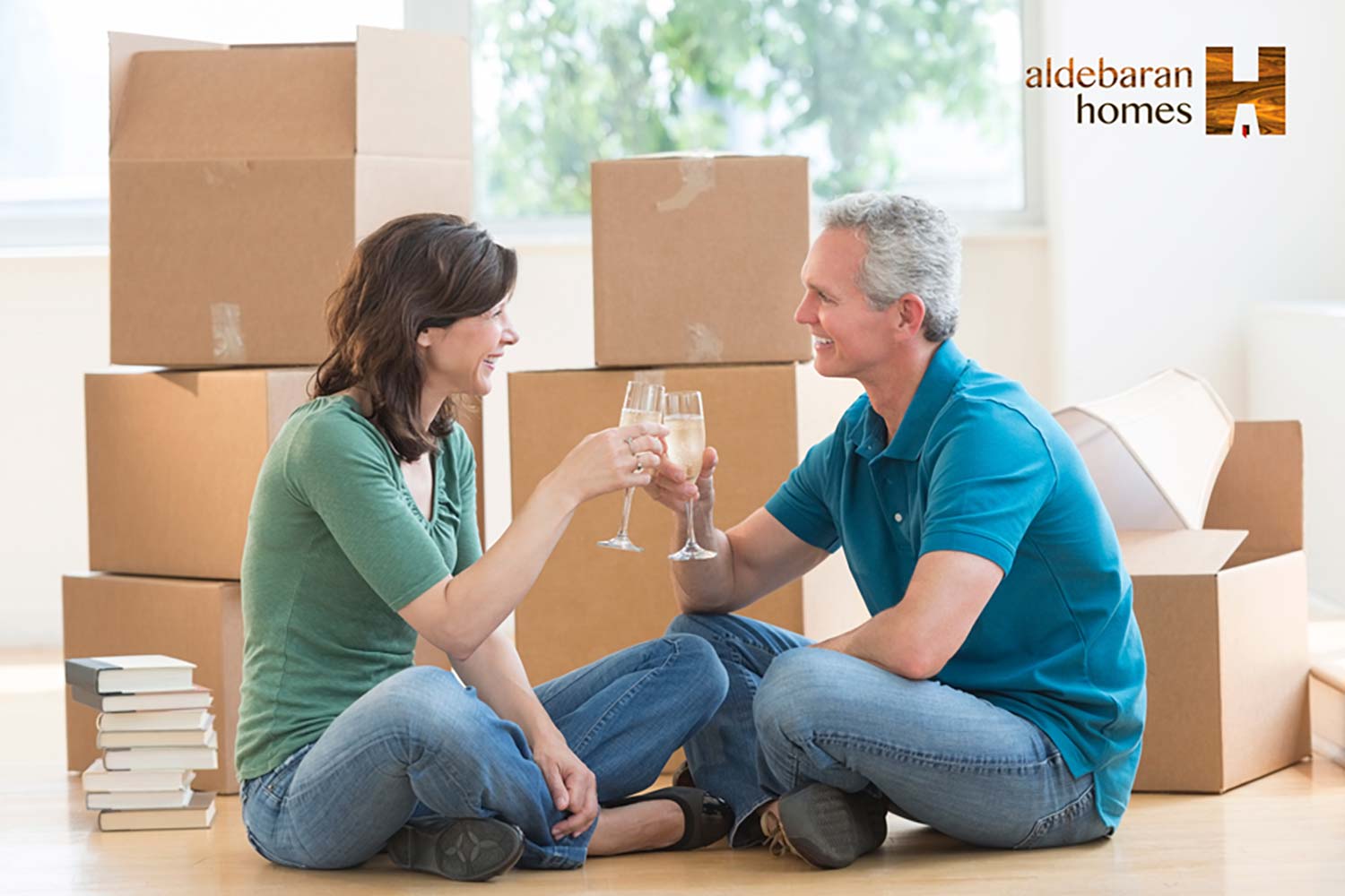 2 people celebrating unpacking after moving into an Aldebaran Home